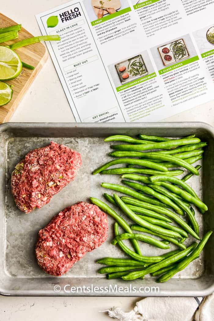 meatloaf and vegetables on a pan to make Meatloaves with a Sweet Chili Glaze