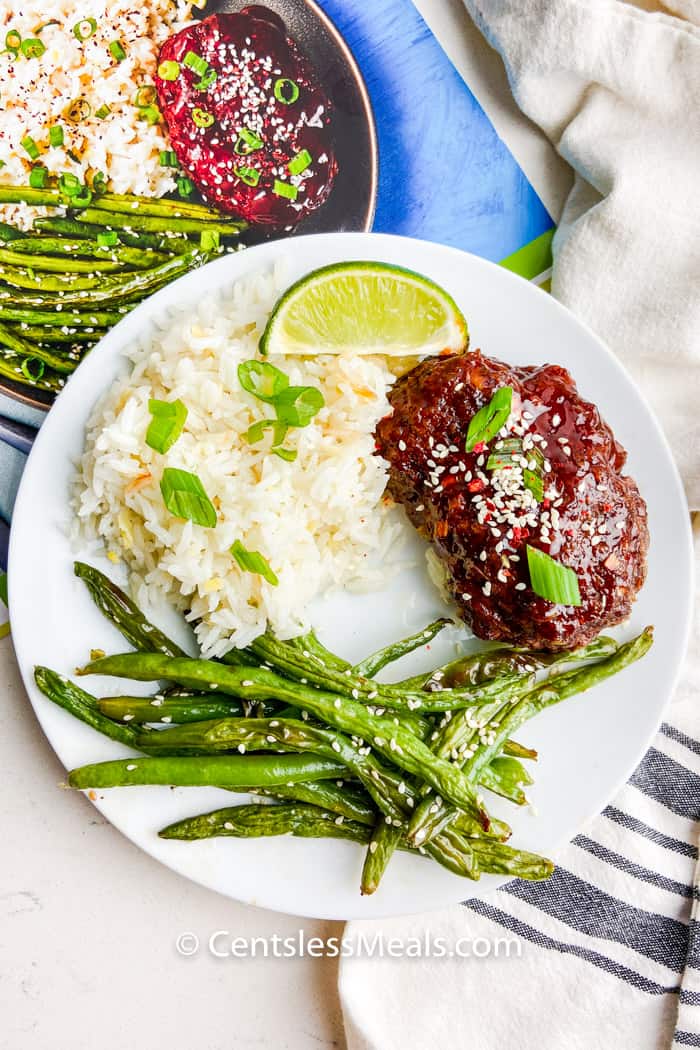 plated Meatloaves with a Sweet Chili Glaze with the recipe book behind it