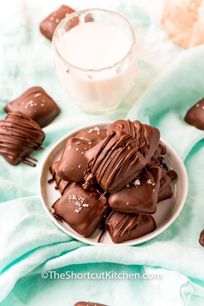 plate of Millionaire Shortbread Bars with a glass if milk