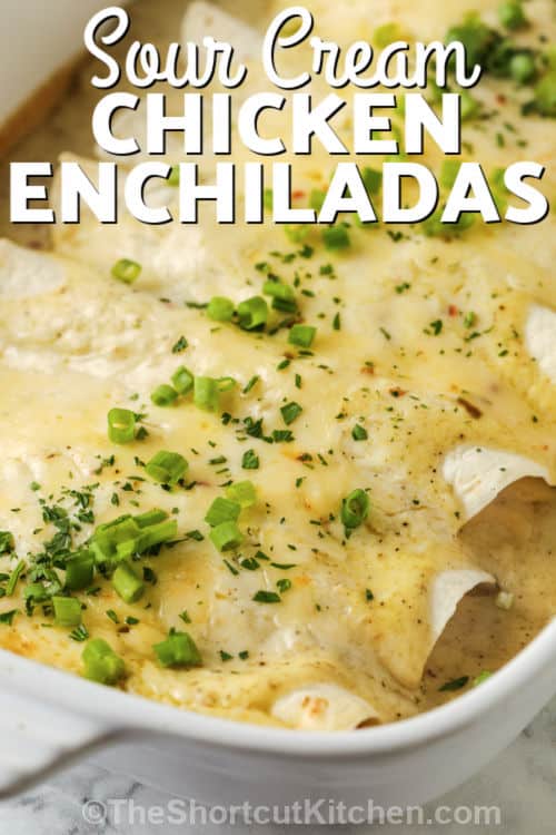 Sour Cream Chicken Enchiladas cooked in a baking dish with writing