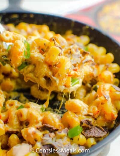 taking a spoonful from a pan of Nacho Mac N’ Cheese