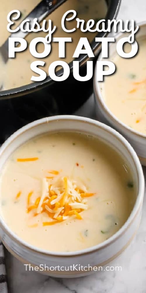 Potato soup in a bowl garnished with cheese, with a title.