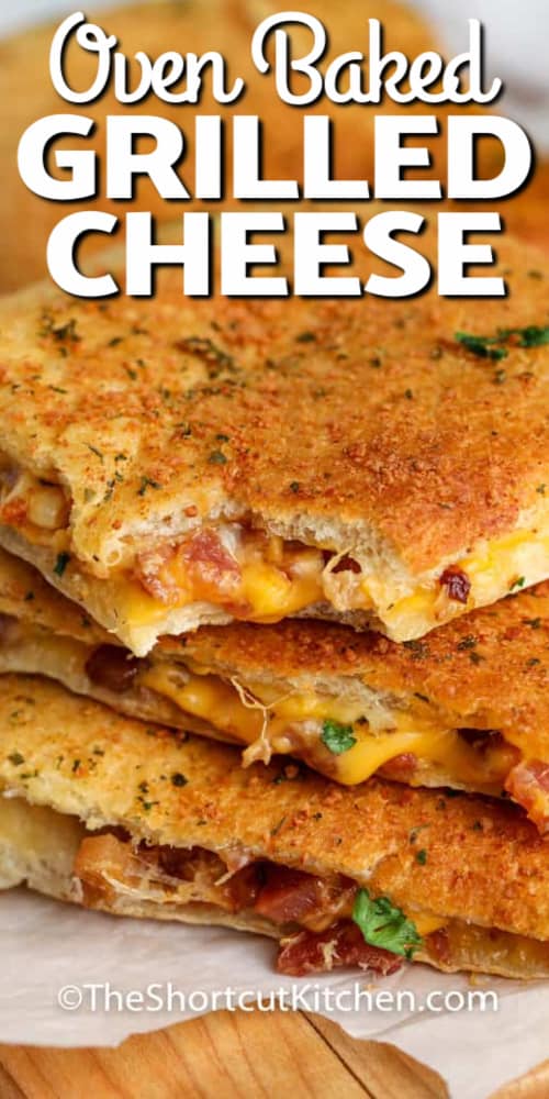 Oven Baked Grilled Cheese piled up and the top one with a bite taken out, with a title