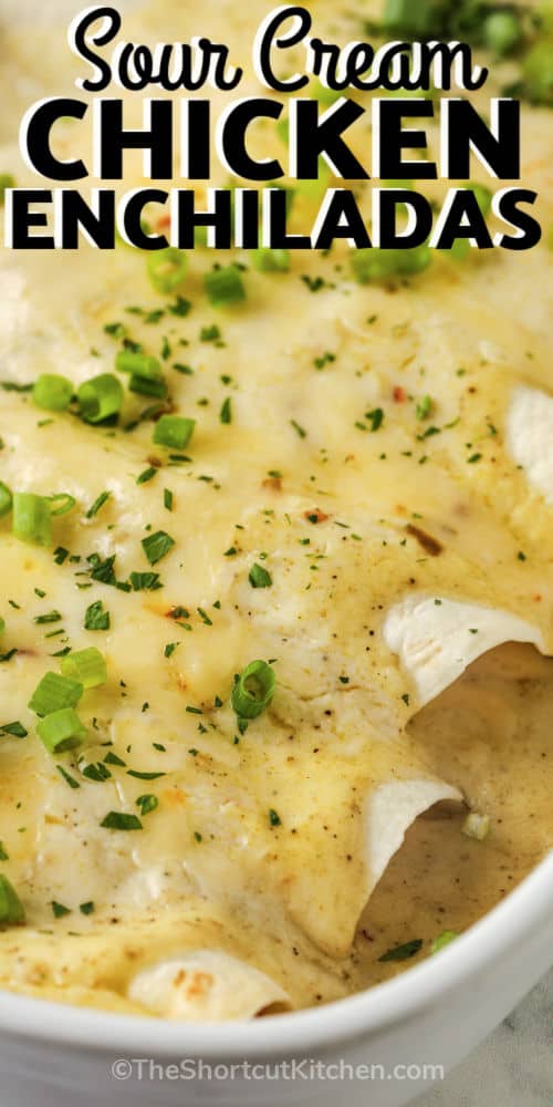 close up of cooked Sour Cream Chicken Enchiladas in the pan with a title