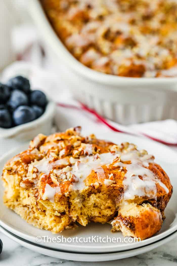 plated Cinnamon Roll French Toast Casserole with dish full in the back