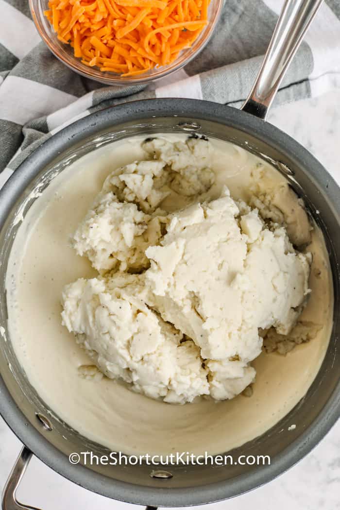 adding potatoes to pot to make Creamy Potato Soup