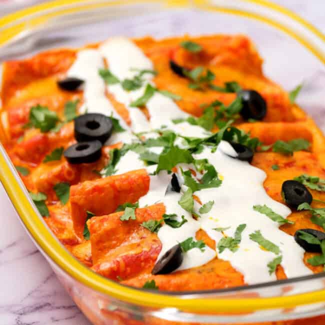 Southwest Shredded Chicken Enchiladas baked in a dish