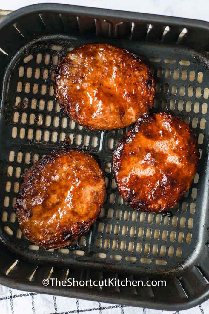 Air Fryer Frozen Burgers cooking in the air fryer