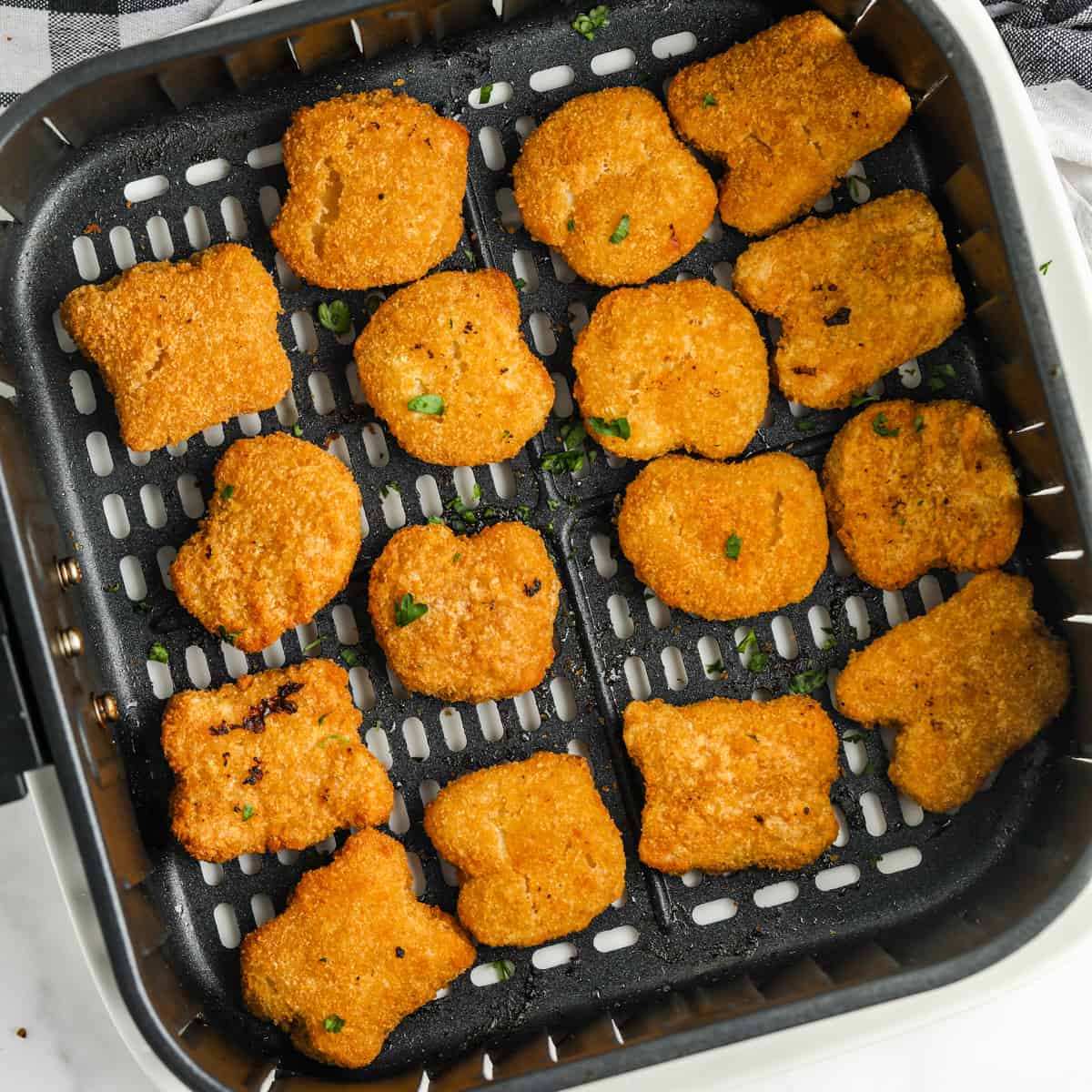 close up of cooking Air Fryer Frozen Chicken Nuggets in the air fryer