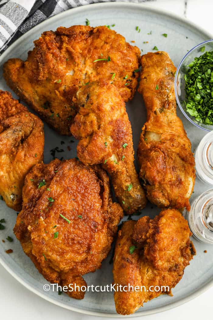 top view of chicken on a plate to show How to Reheat Fried Chicken in the Air Fryer