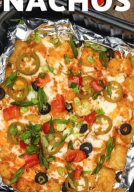 Air Fryer Nachos in a foil lined air fryer basket with toppings assembled on the side, with writing.