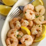 Air Fryer Frozen Shrimp cooked and served in an oval dish.