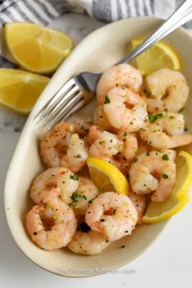 Air Fryer Frozen Shrimp cooked and served in an oval dish.