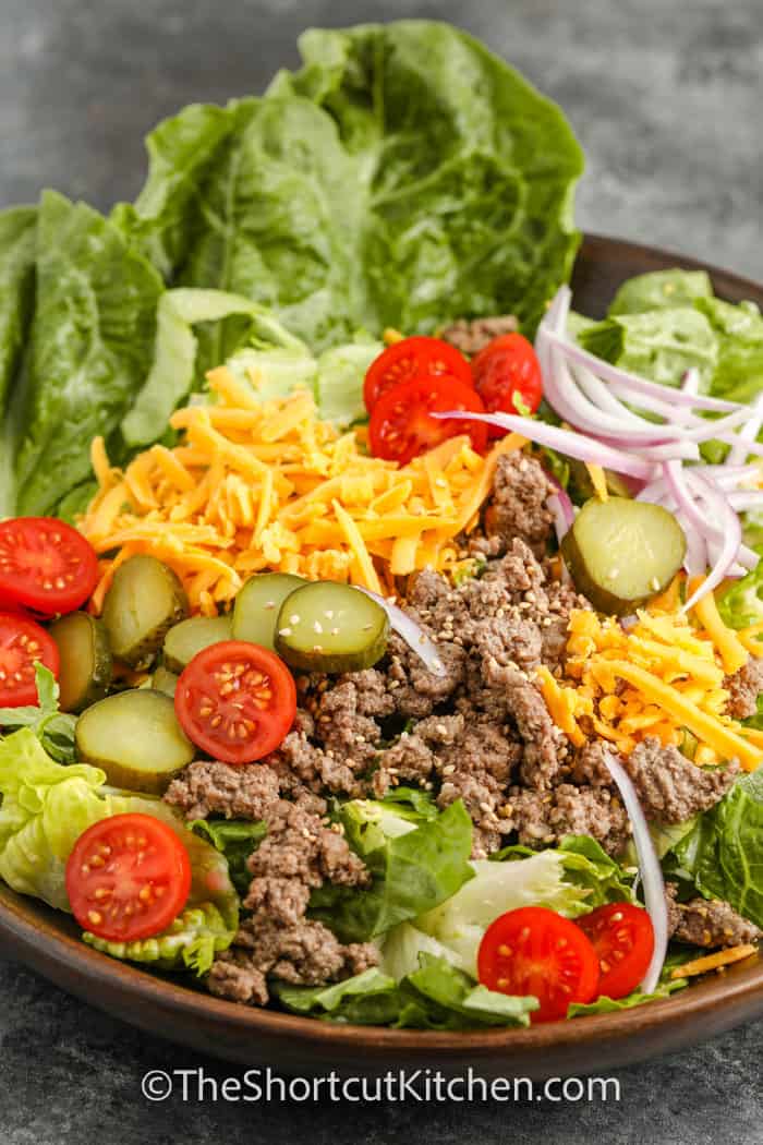 Cheeseburger Salad in a bowl with pickles
