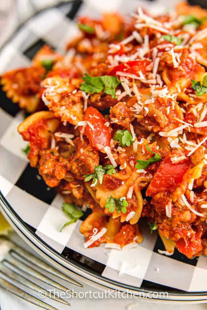 Sausage and Peppers Pasta with cheese on a plate with a fork