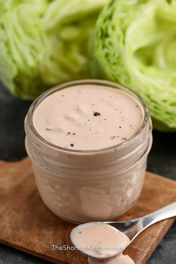 thousand island dressing in a glass jar with lettuce