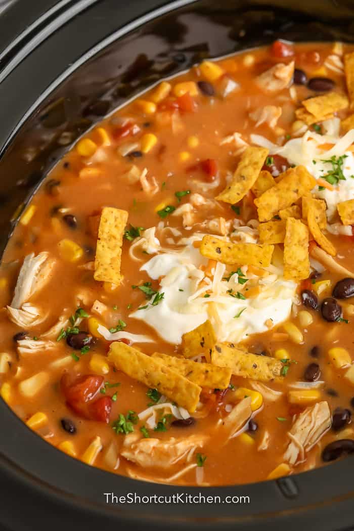 close up of crock pot chicken tortilla soup in crock pot