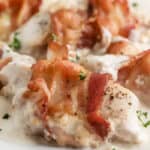 close up of bacon wrapped sour cream chicken