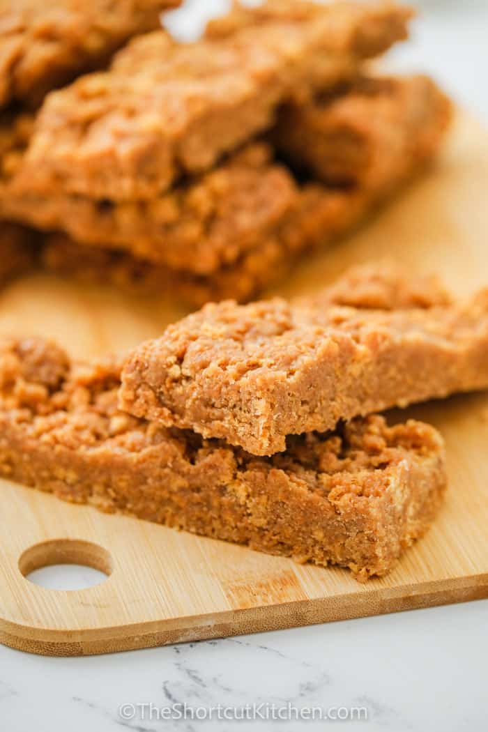 Peanut Butter Breakfast Bars in a pile on a wooden board