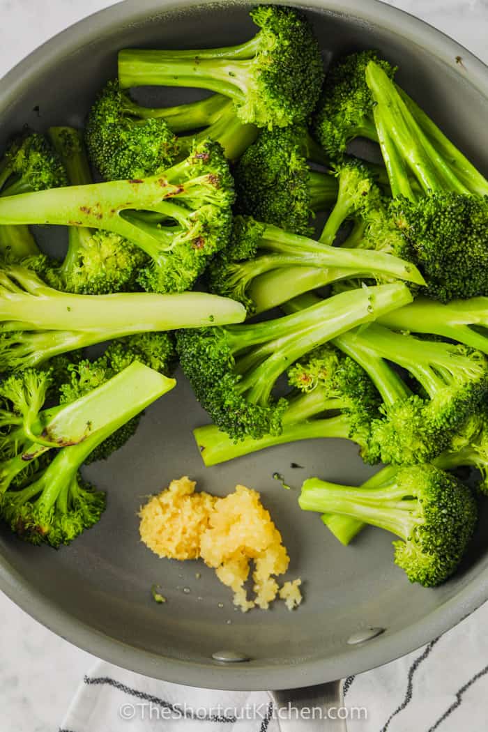 adding ingredients to pan to make Stir Fried Broccoli