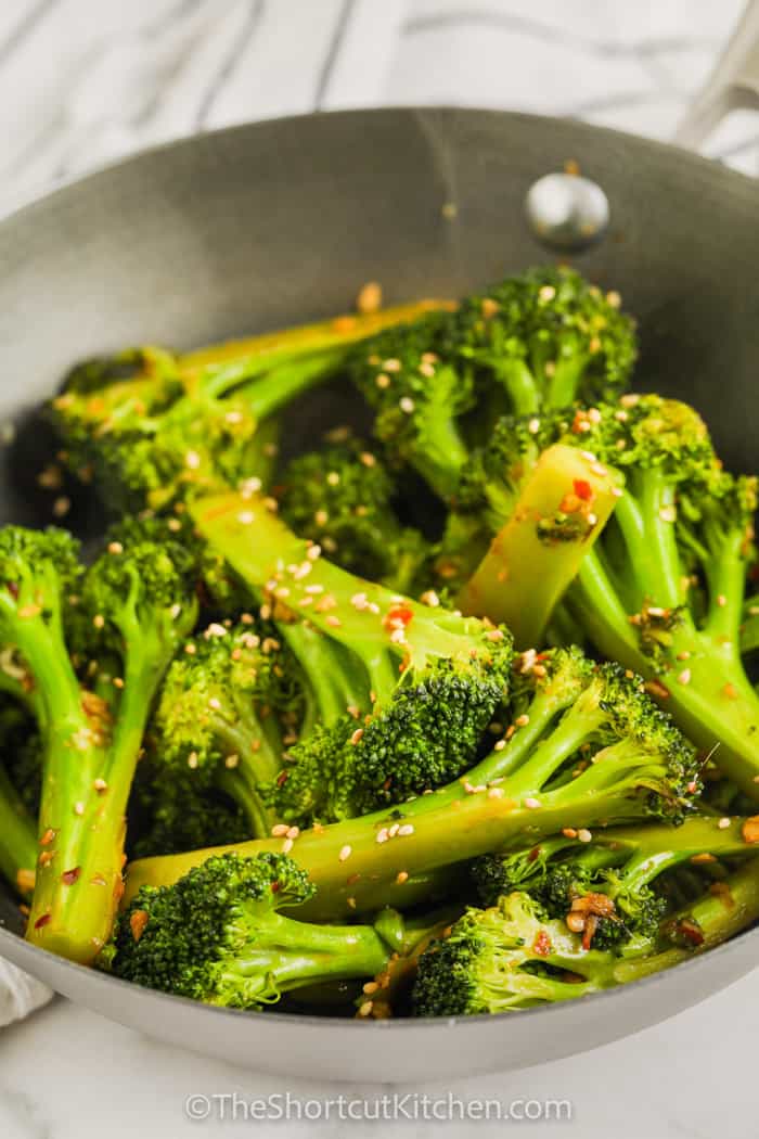 adding sauce and seasoning to Stir Fried Broccoli