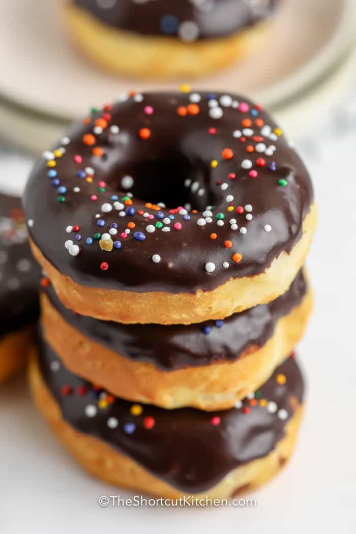 stack of chocolate dipped donuts with sprinkles