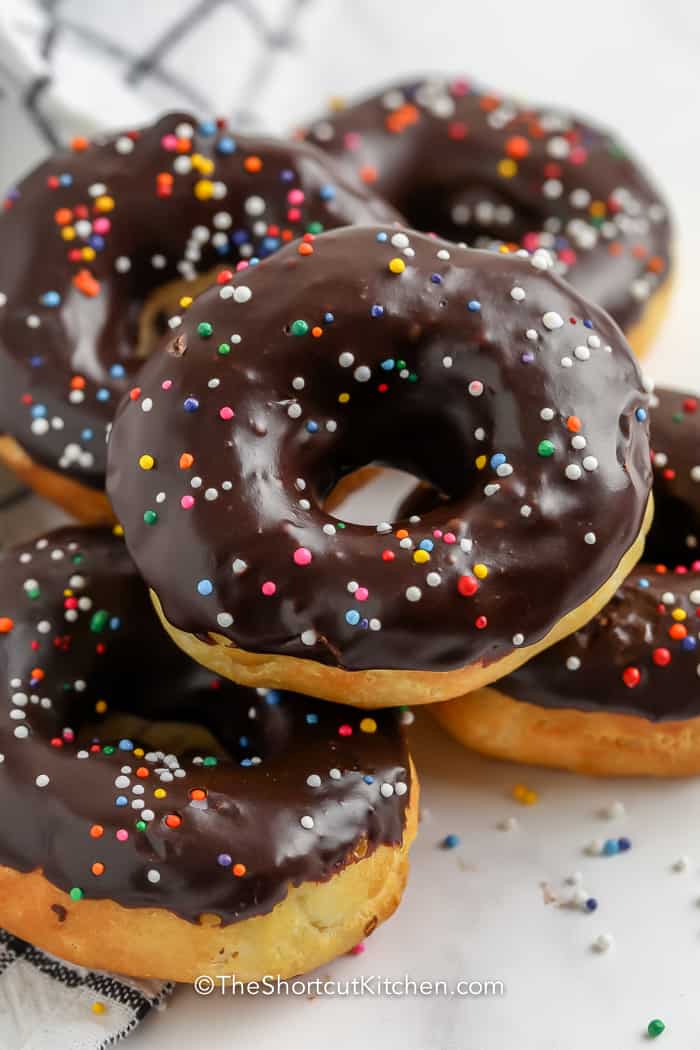 pile of chocolate dipped donuts with sprinkles