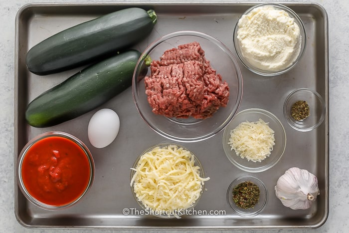 Ingredients assembled to make lasagna stuffed zucchini boats