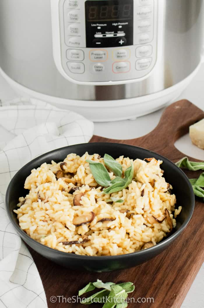 Instant Pot Mushroom Risotto in a bowl with instant pot in the background