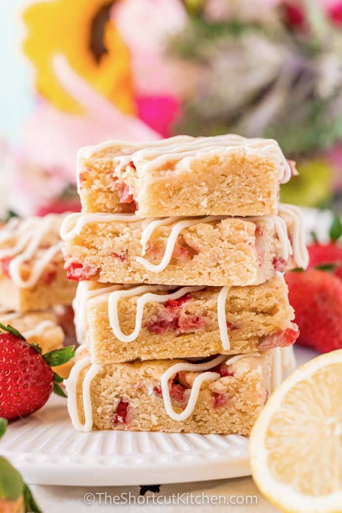 plated pile of Strawberry Shortcake Bars with a bite taken out of one