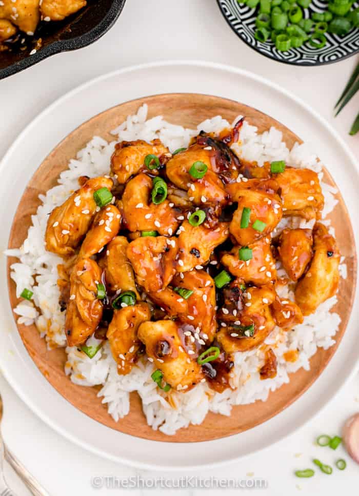 Sweet & Sour Chicken in a bowl with rice and green onions