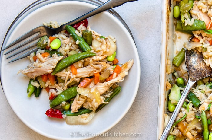 Teriyaki Chicken and Rice Casserole on a plate with dish full beside it