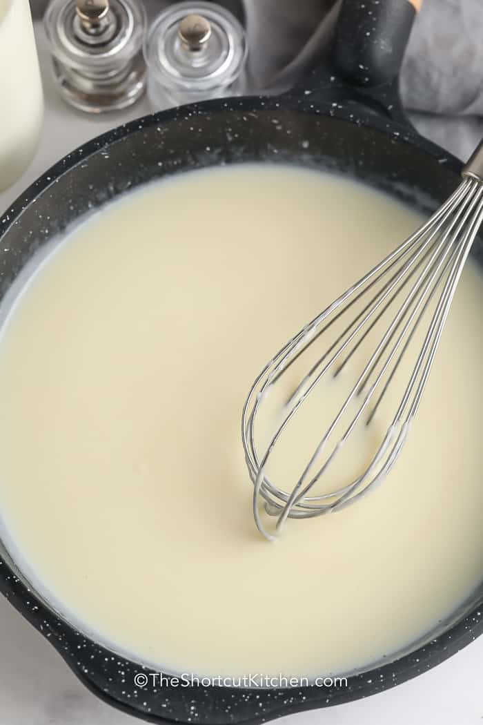 white gravy mixed in a pan