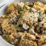 a serving dish of creamy crockpot chicken thighs with mushrooms