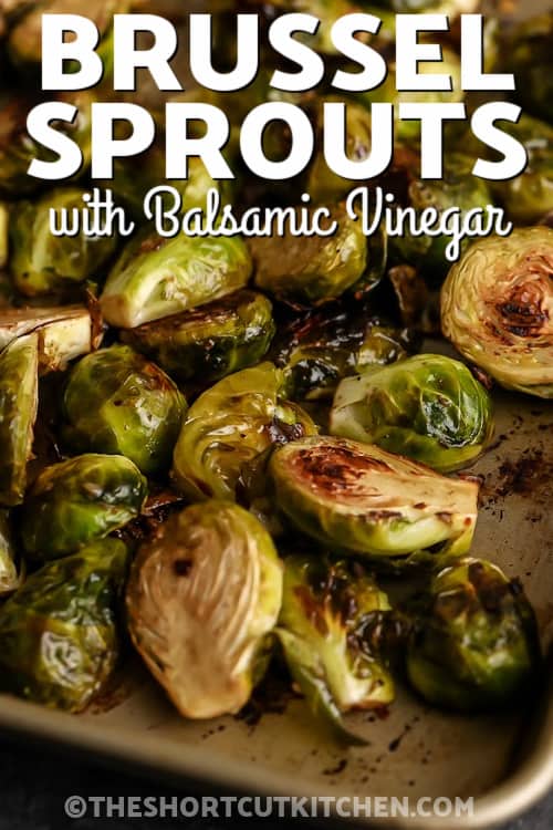 Roasted Brussel Sprouts with Balsamic Vinegar on a baking tray with writing