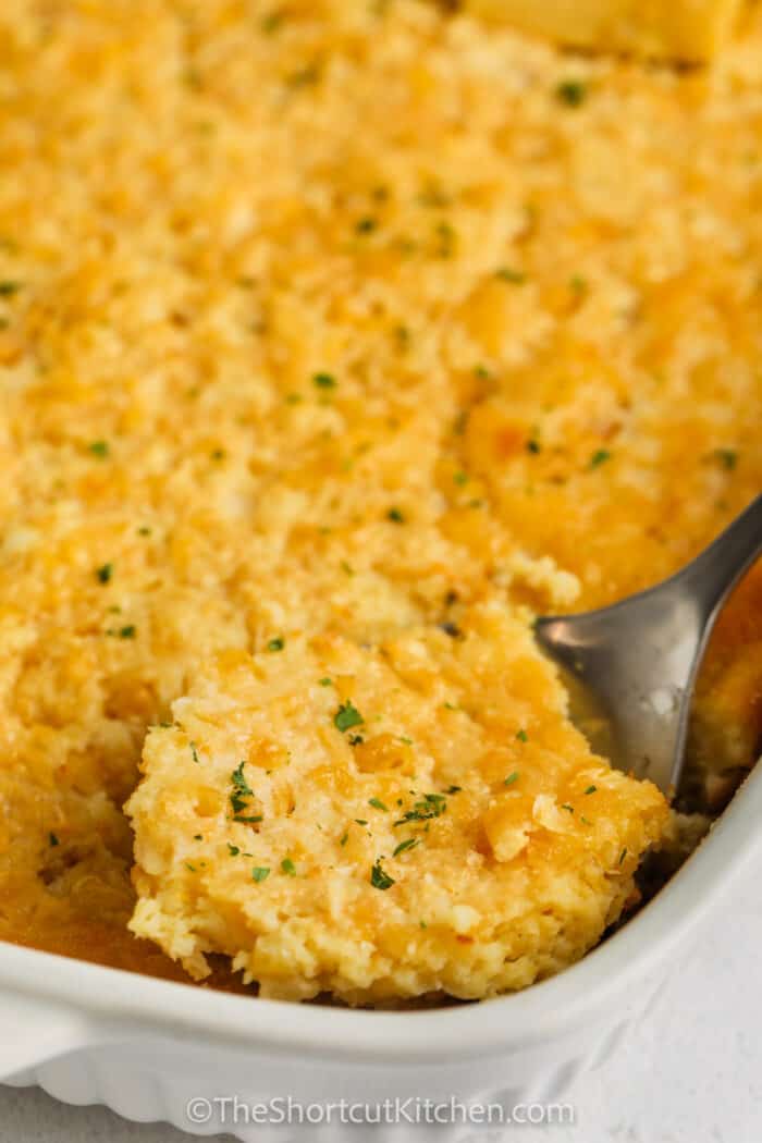 close up of taking a slice out of a Corn Pudding Casserole