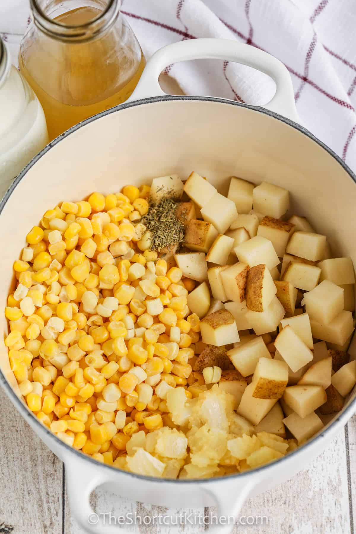 adding ingredients to pot to make Easy Potato Corn Chowder