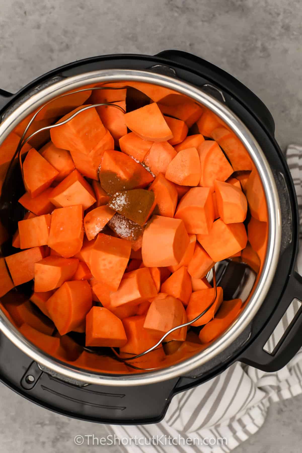 Easy Instant Pot mashed sweet potatoes are the cozy side dish that belongs beside almost any main course. Fresh sweet potatoes are pressure cooked until tender, mashed with butter, then finished with warm milk or cream for a rich and creamy texture. Add cinnamon for holiday flavor or skip it for an everyday savory side. This pressure cooker sweet potatoes recipe is simple and ready in 30 minutes. Pin it for later! #theshortcutkitchen ingredients in an instant pot to make Instant Pot Mashed Sweet Potatoes