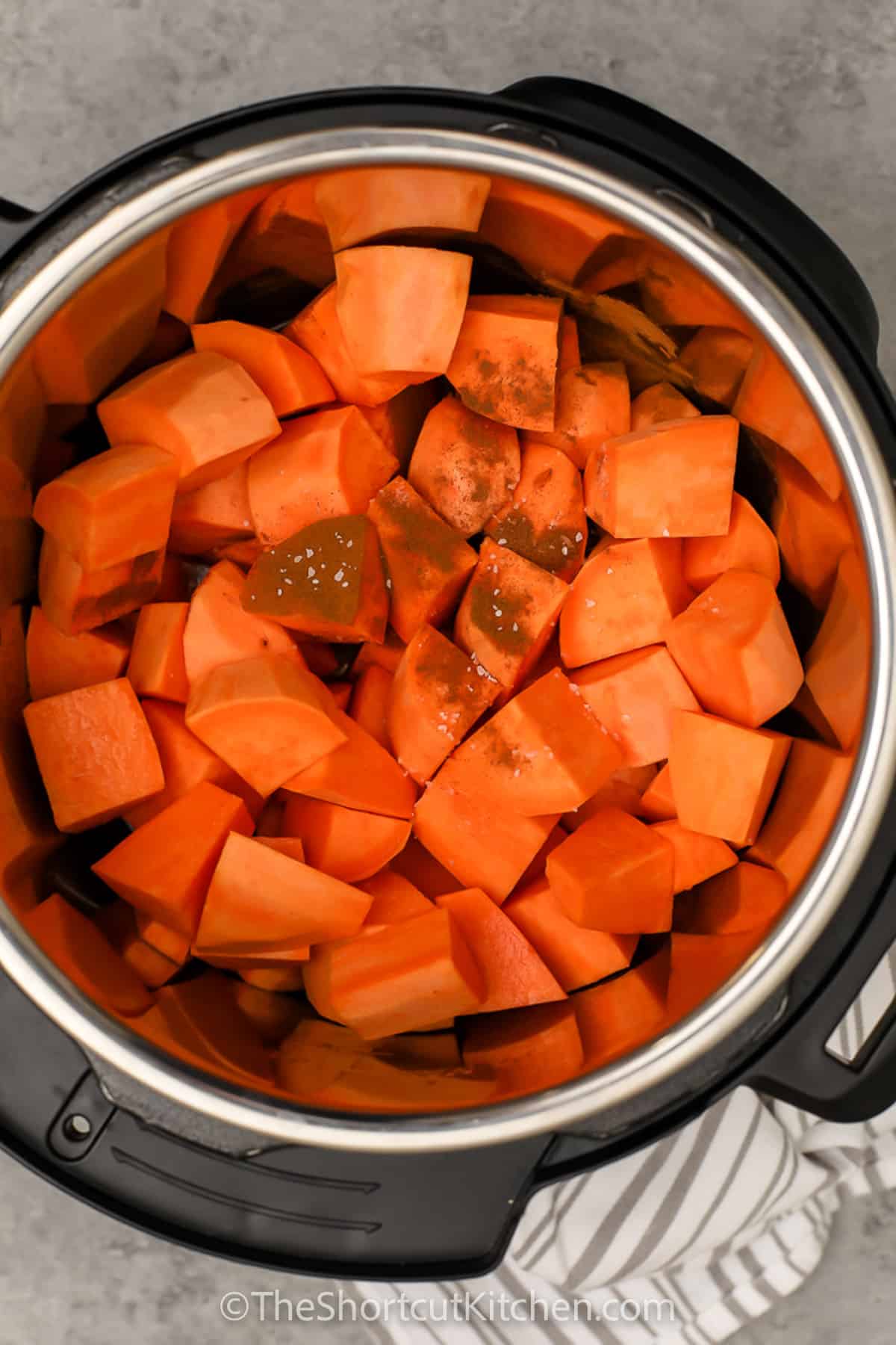 adding ingredients to pot to make Instant Pot Mashed Sweet Potatoes