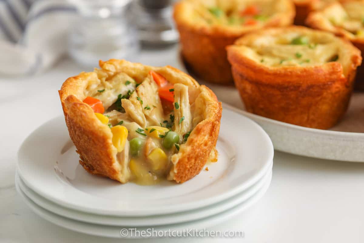 Mini Chicken Pot Pies on a plate with a bite taken out of one