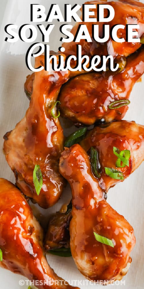 A plate of soy sauce chicken drumsticks with writing