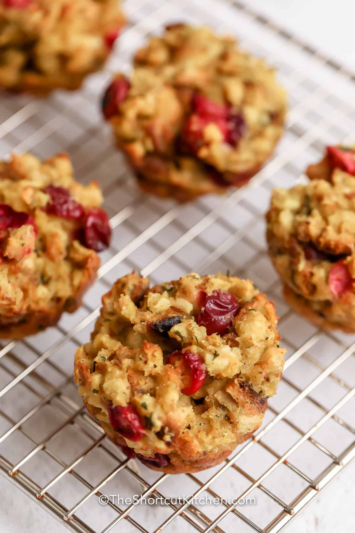 Close up of Cranberry Stuffing Muffins on a cooling rack