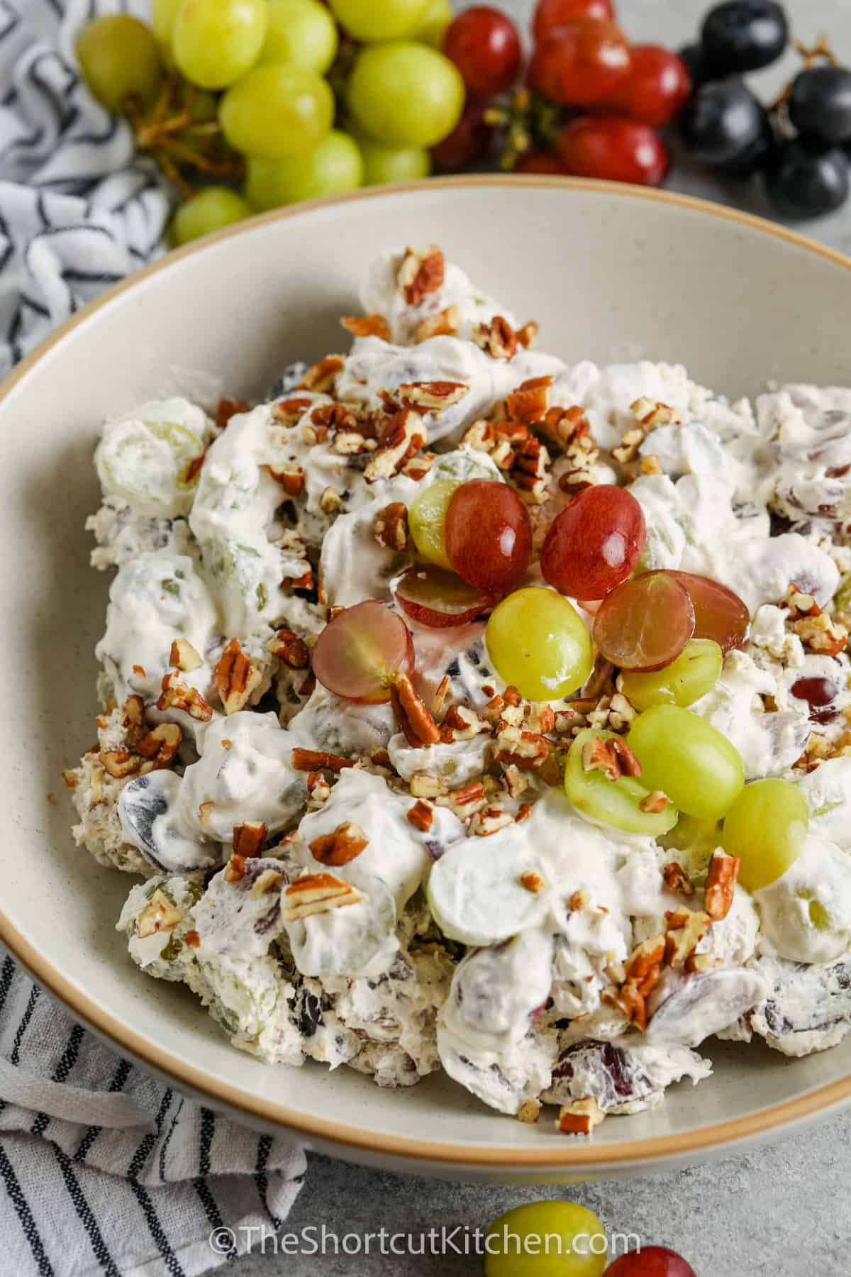 bowl of Easy Grape Salad with grapes around it