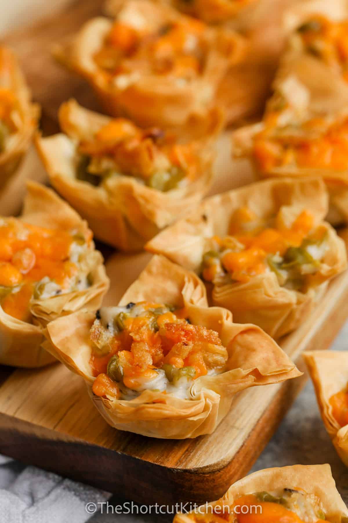 Green Bean Bites on a wooden cutting board