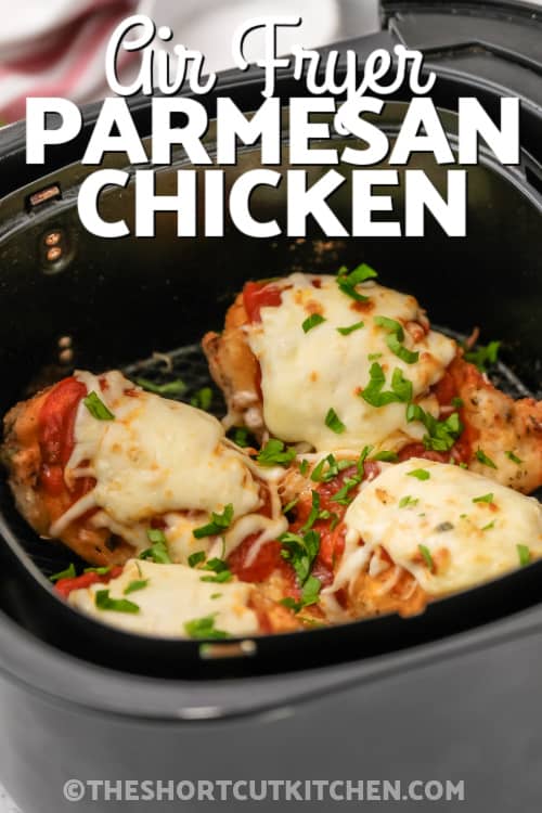 Chicken Parmesan in an air fryer basket with writing