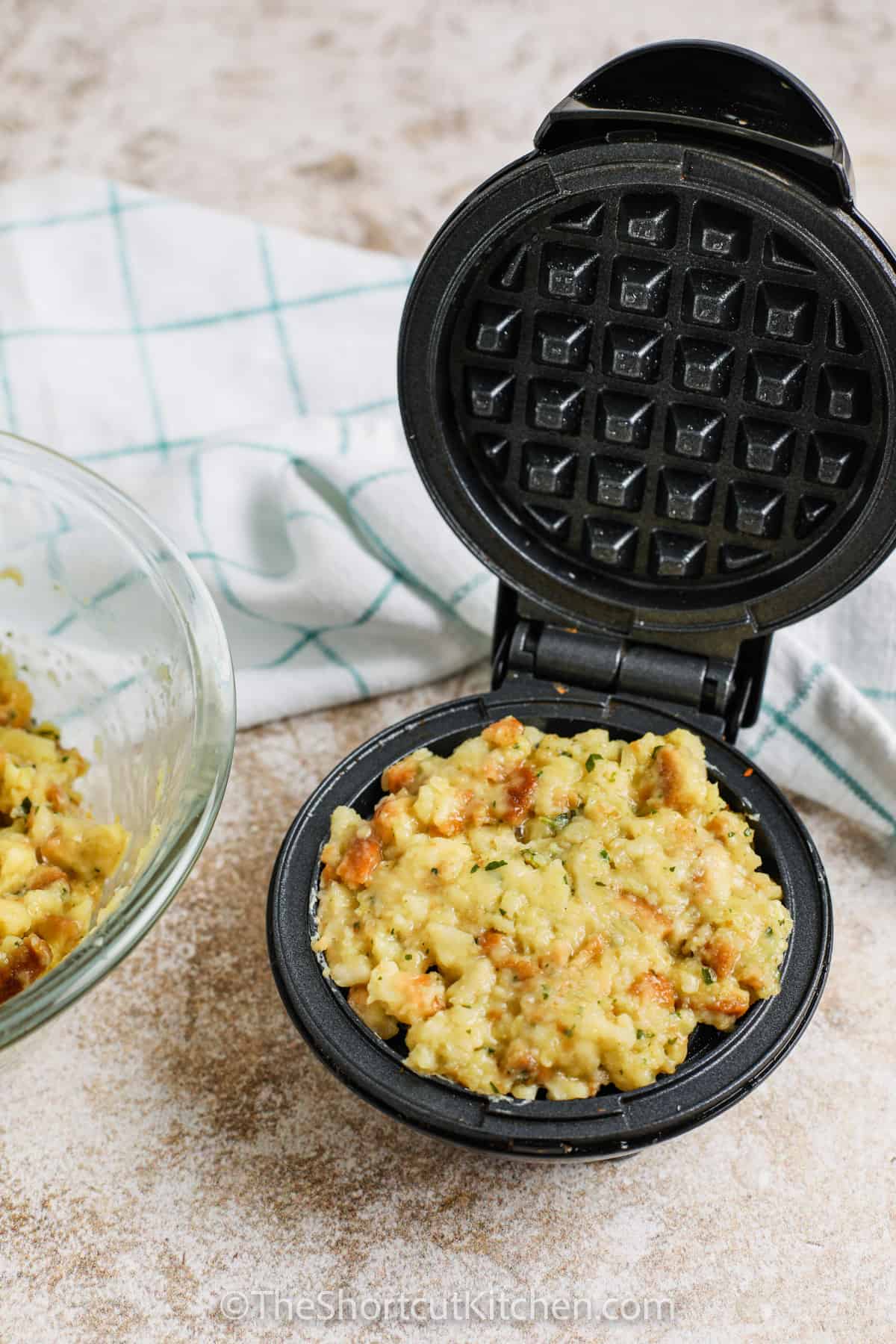 adding ingredients to waffle maker to make Stuffing Waffles