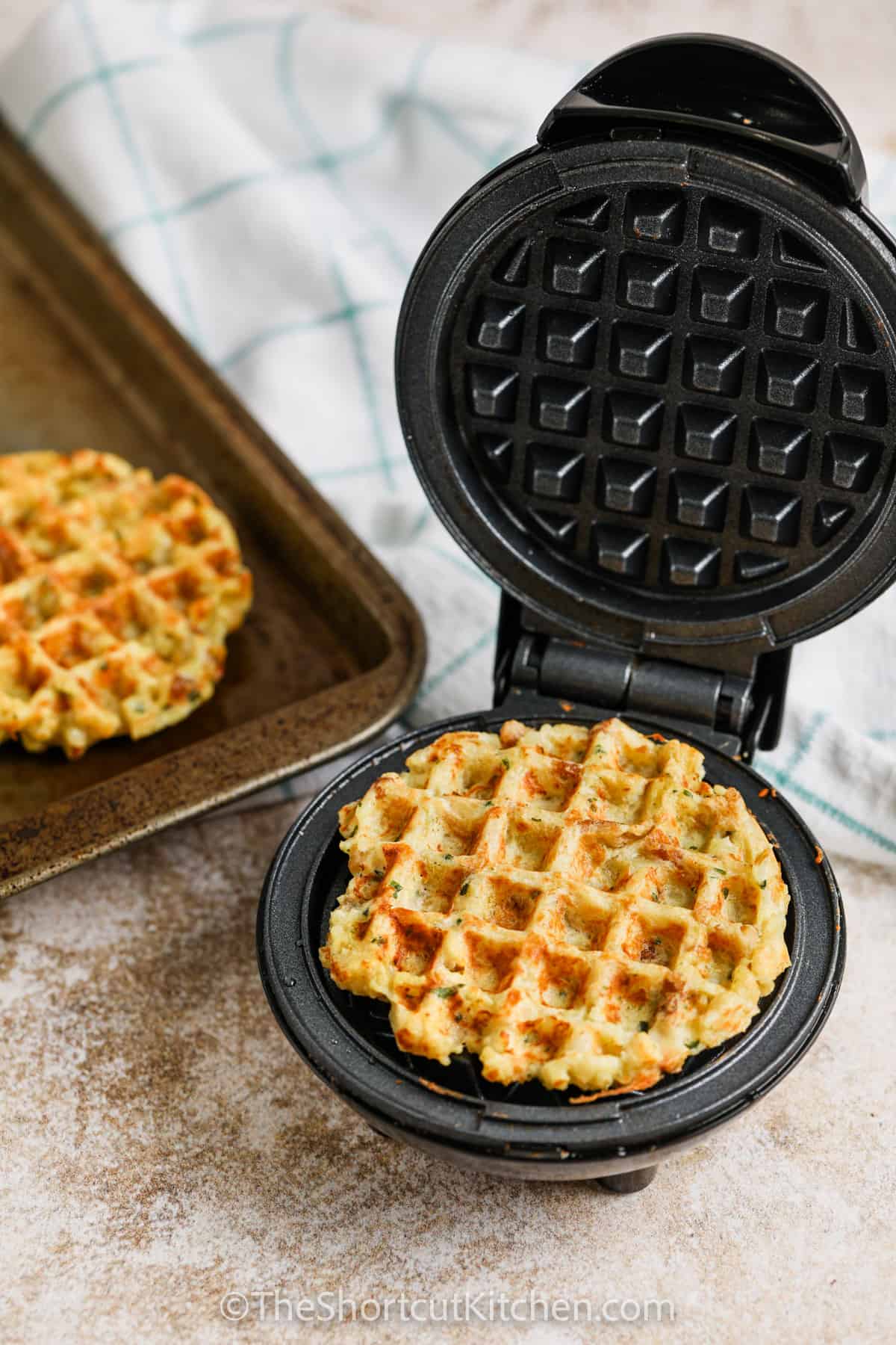 Stuffing Waffles in a waffle maker after cooking