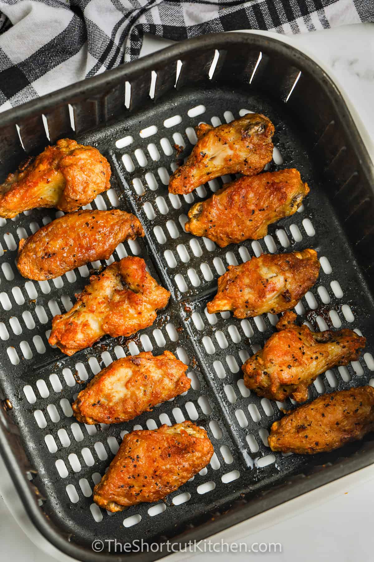 Cooked Chicken Wings in an air fryer basket