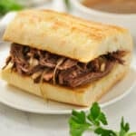 plated Crock Pot French Dip Recipe with dip in the back