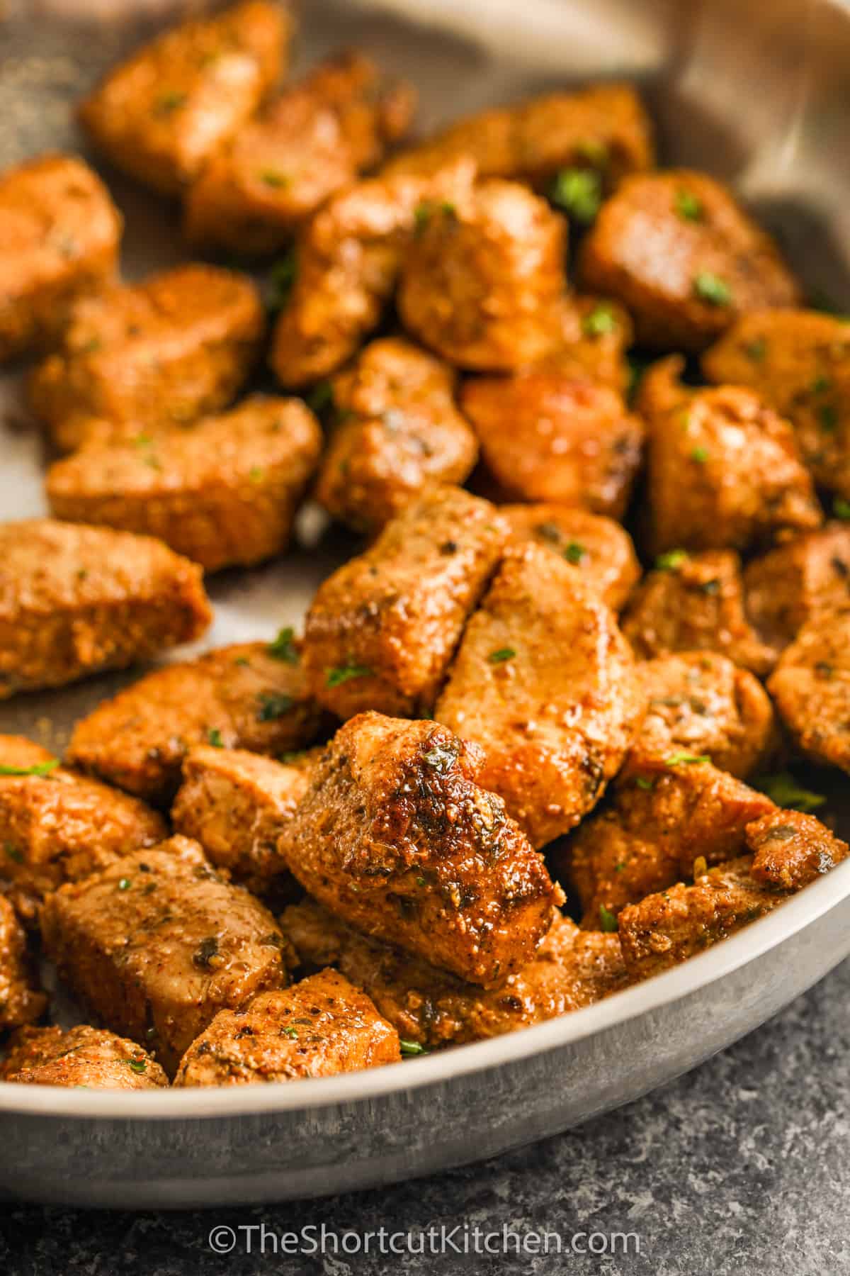 Close up of pork bites in a pan